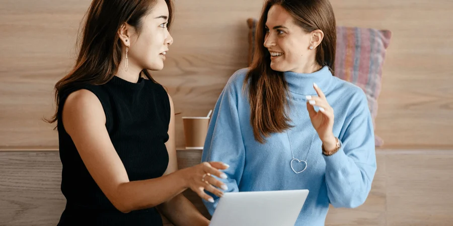 Two women looking at a laptop
