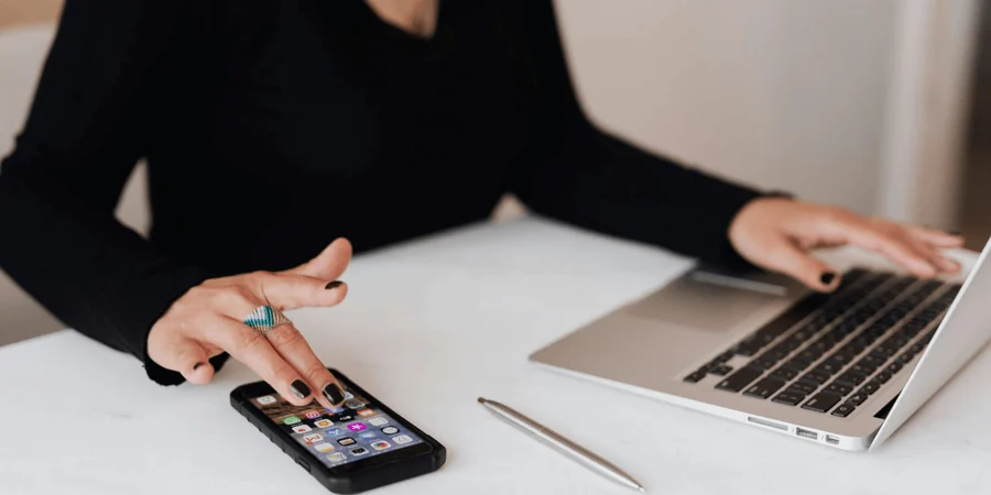 Woman using mobile and laptop